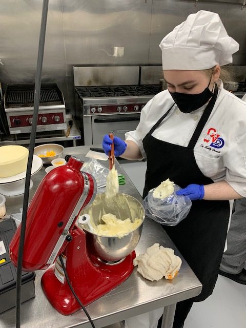 12th grader Jenna Belmont working in the Culinary Arts kitchen.
