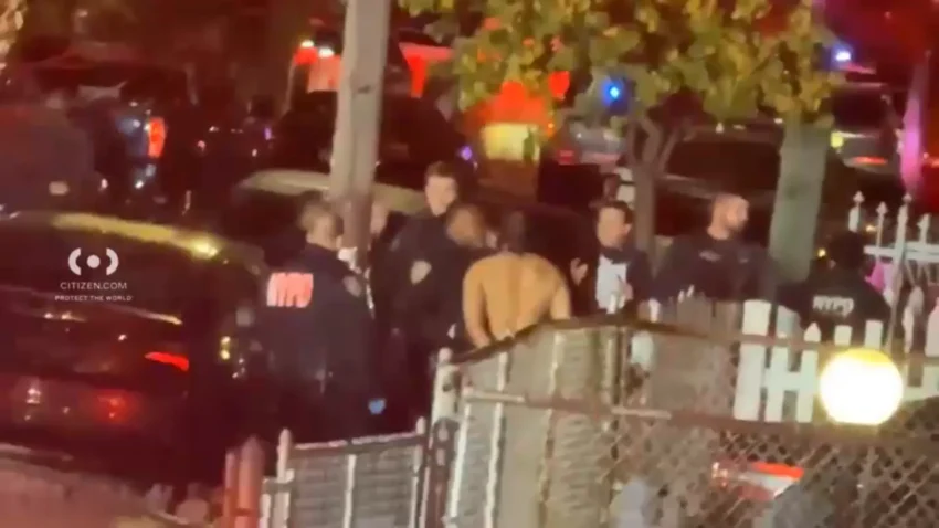 Police vehicles outside a South Ozone Park home after an NYPD shooting and stabbing response