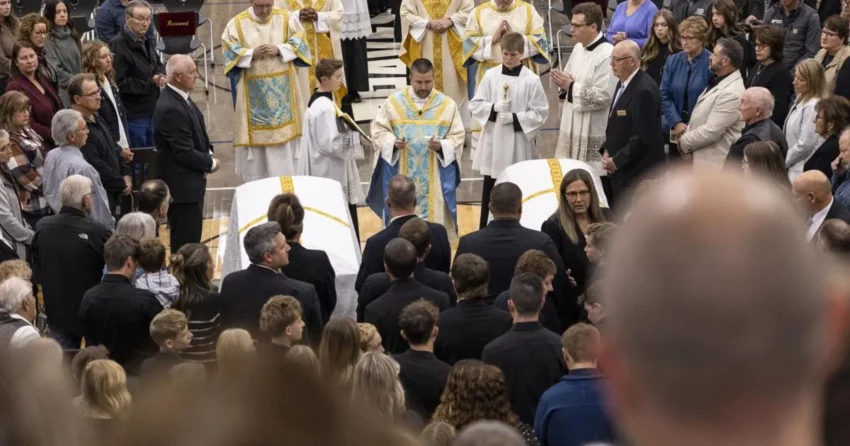 Mourners attend a joint funeral Mass for two Mandan High School students in a packed gymnasium