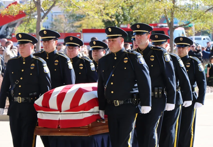 Law enforcement officers gather inside the Premier Center for Katherine Frank's funeral