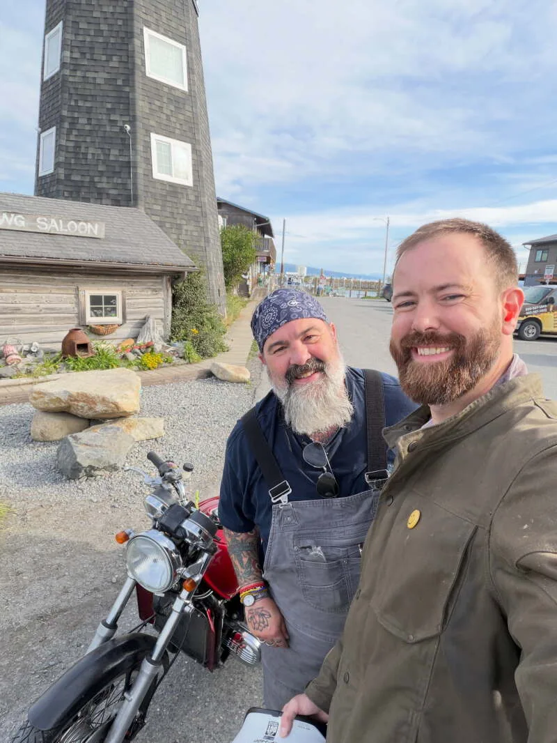 A rider on a red Honda Gold Wing motorcycle during a long trip home from Alaska