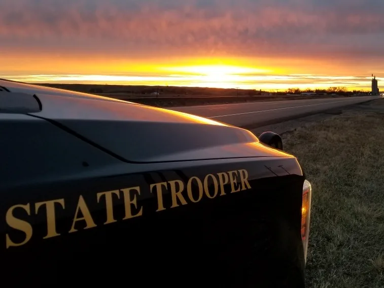 Police investigate a motorcycle crash on a rural road near Bismarck, North Dakota